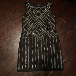 White house black market dress. Black with gold and silver sparkles.